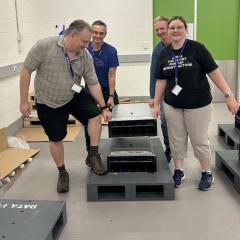 The RCC team installing hardware for Bunya Phase 3 at the Polaris Data Centre.