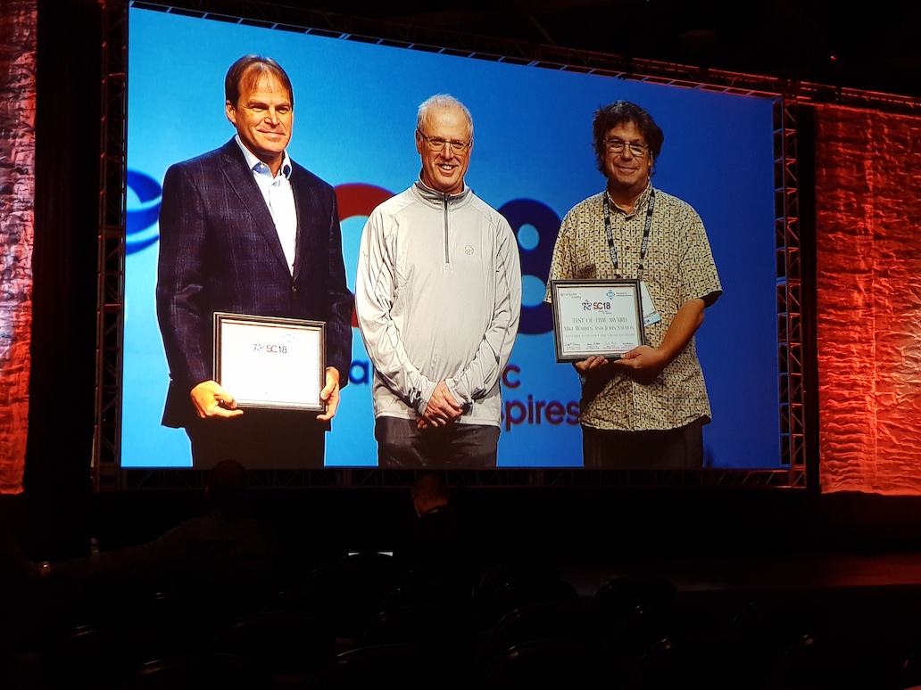 RCC Director Prof. David Abramson (centre) presenting the SC18 Test of Time Award to Mike Warren (left) and John Salmon (right). (Photo: Mark Endrei, RCC.)