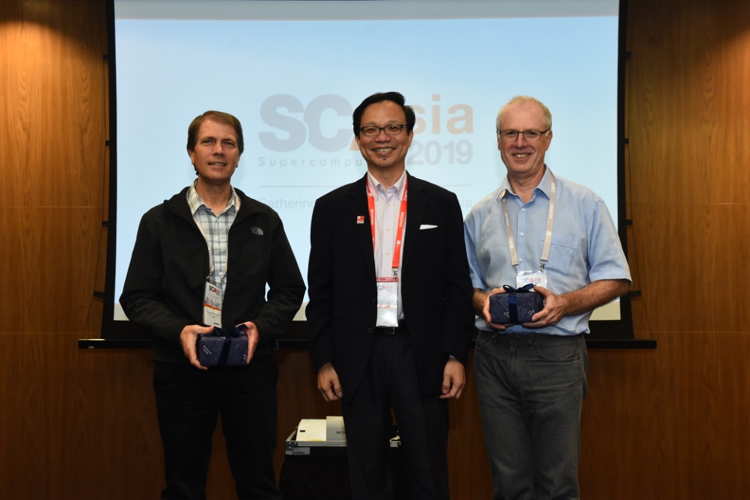 SCA19 Organising Committee Chair Prof. Tan Tin Wee, CEO of NSCC Singapore, presented gifts to RCC Director Prof. David Abramson and Prof. Bronis R. de Supinski, CTO of Livermore Computing, for their work on the conference program committee. Image courtesy of SCA19.