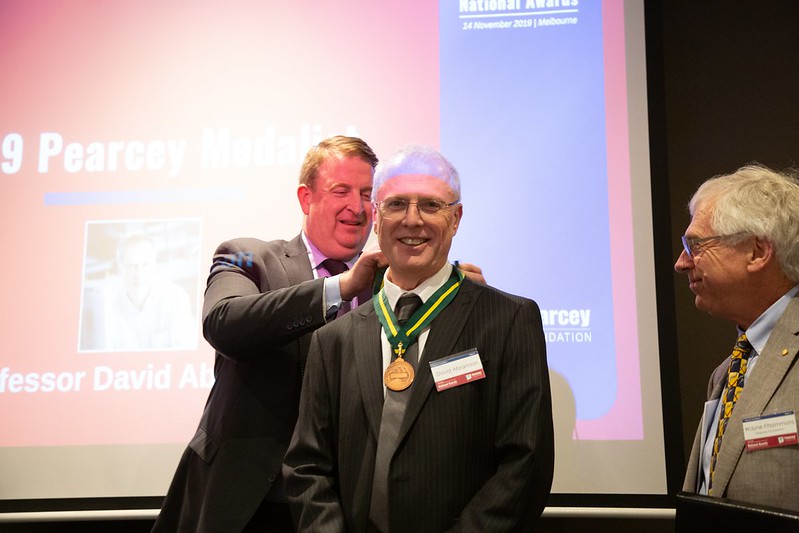  Professor David Abramson (middle) receiving the 2019 Pearcey Medal from Nigel Warren, Executive Director Growth, CSIRO (left), with Pearcey Foundation chairman Wayne Fitzsimmons (right).  (Photo:  Karl von Moller.)