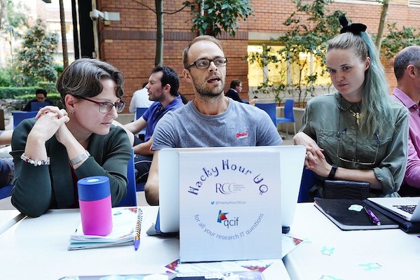 Dr Nick Clark (middle) and his research assistant Sabrina Gericke (right) at UQ's Hacky Hour last year receiving IT help with their research from RCC eResearch Analyst Dr Marlies Hankel. (Photo: Dr Nick Hamilton.)
