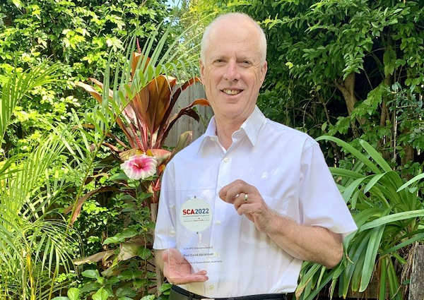 Professor David Abramson in his home garden shortly after receiving his SCA2022 HPC Visionary Award plaque by courier. (Photo courtesy of David Abramson.)