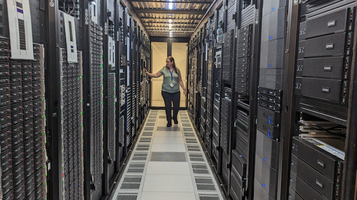 RCC's Sarah Walters checking UQ hardware at the Polaris Data Centre in Springfield, Queensland, including HPC Bunya's racks. (Photo by Ashley Wright, RCC.)