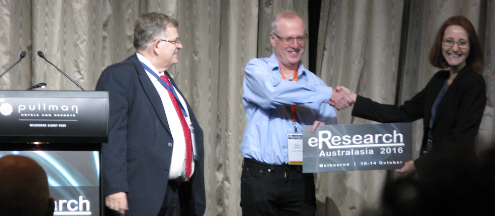Past eResearch Australasia Conference co-Chairs Nick Tate (left) and Viviani Paz (right) formally handed over the reins to RCC Director Prof. David Abramson (centre) at the conference in Melbourne last week.